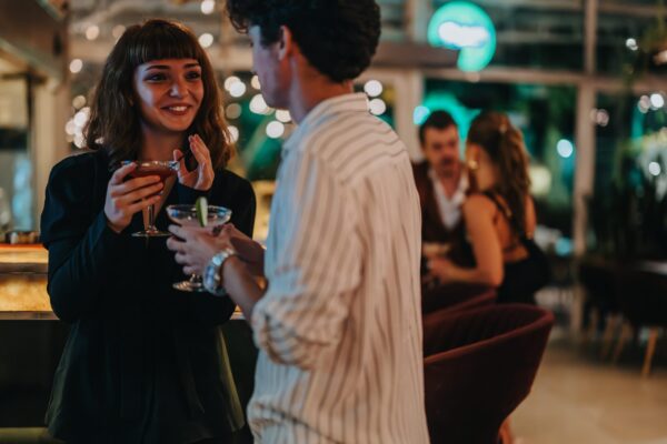 A,Group,Of,Friends,Socializing,At,A,Trendy,Bar,During